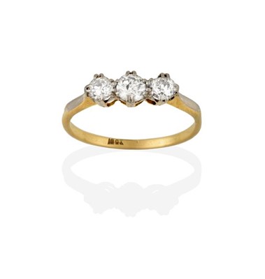 Lot 2223 - A Diamond Three Stone Ring, the graduated...