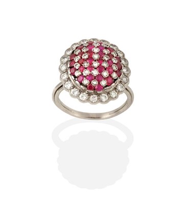 Lot 2229 - A Ruby and Diamond Ring, the central oval dome...