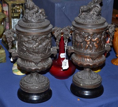 Lot 206 - Pair of decorative urns with cherub lids on wood bases