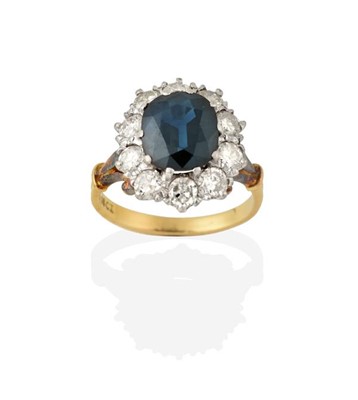 Lot 2256 - A Sapphire and Diamond Cluster Ring, the oval...