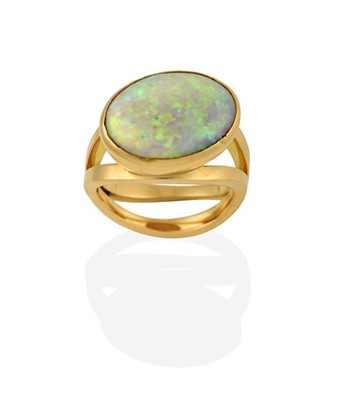 Lot 2268 - An 18 Carat Gold Opal Ring, the oval cabochon...