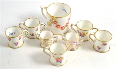 Lot 213 - A Royal Crown Derby coffee can, four miniature Royal Crown Derby loving cups and three...