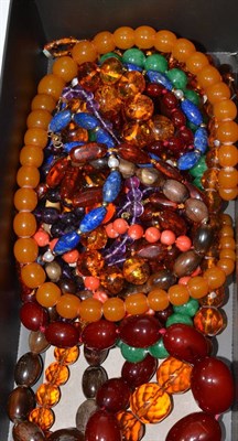 Lot 216 - A collection of assorted beads including a cherry amber type necklace