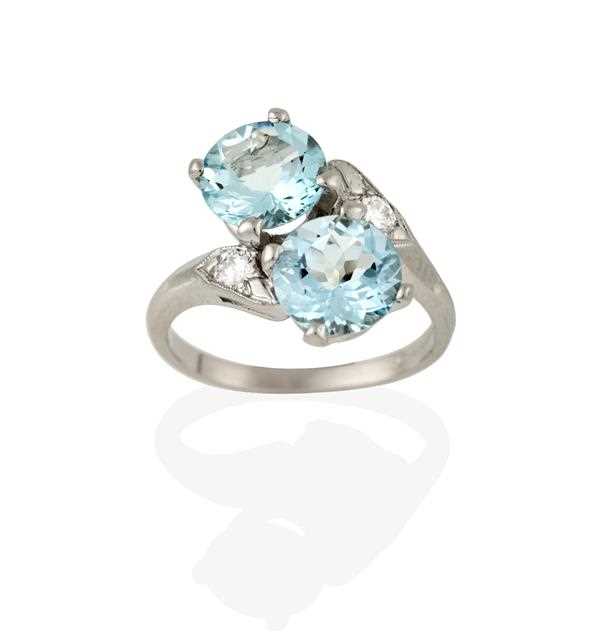 Lot 2346 - An Aquamarine and Diamond Ring, the round cut...