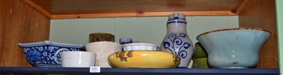 Lot 228 - A shelf including pottery bowls, modern Chinese blue and white dish, three pottery jelly...