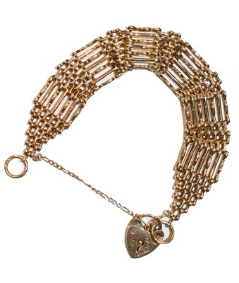 Lot 250 - A 9 carat gold gate link bracelet with a heart...