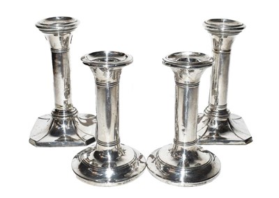 Lot 79 - Two pairs of silver candlesticks, filled (4)