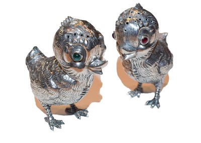Lot 255 - Pair of white metal 'chick' pepperettes,...