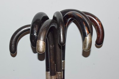 Lot 309 - Seven silver mounted ebonised walking sticks (7)