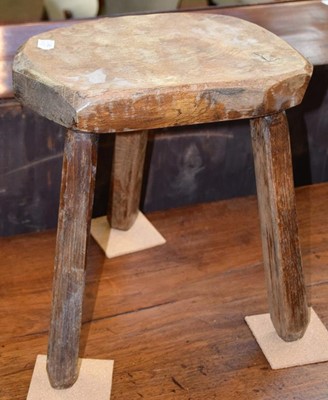 Lot 1243 - A rustic elm bench with an adzed top and...