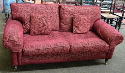 Lot 1276 - A modern red upholstered two seater sofa