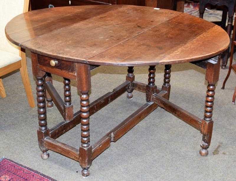 Lot 1303 - An 18th century double gateleg table, 143cm by...