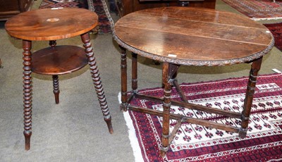 Lot 1310 - A 1920's oak gateleg table with lunette carved...