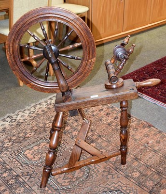 Lot 1328 - An elm spinning wheel