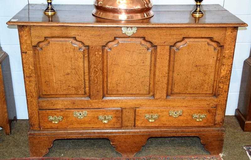 Lot 1333 - A George III oak mule chest, the front with...