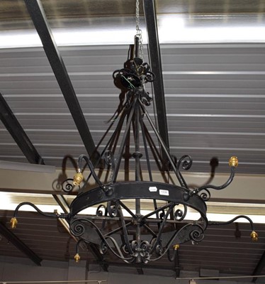 Lot 1338 - A black painted wrought metal chandelier with...