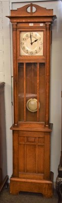 Lot 1209 - An Art Deco oak longcase clock, 11.5''...
