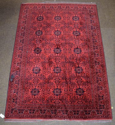 Lot 1283 - Afghan Turkman rug, the blood red field with...