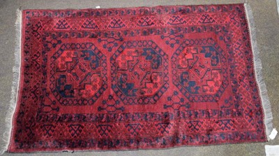 Lot 1288 - Afghan Turkmen rug, the claret field with...
