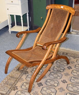 Lot 1159 - A walnut framed and cane seated folding...