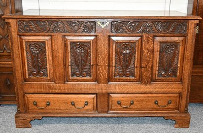Lot 1162 - A 20th century carved oak mule chest in the...