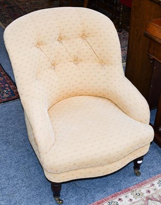 Lot 1174 - A buttoned tub chair with a mahogany frame