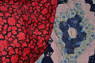 Lot 319 - Floral cotton quilt in red and pink on a black cotton ground with a white reverse and a silk...