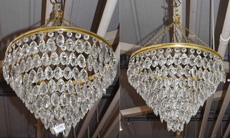 Lot 1198 - A pair of seven-tier chandeliers with cut...