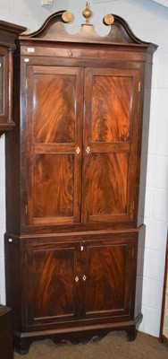 Lot 1214 - A George III mahogany standing corner cupboard...