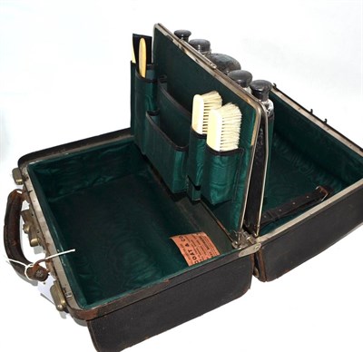 Lot 337 - Gladstone bag with green silk lining, silver mounted glass bottles etc