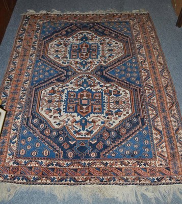 Lot 401 - An Afshar rug, South East Persia, the indigo field with two stepped medallions framed by...