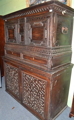 Lot 405 - A 19th century carved oak court cupboard with fret mounted panels to the cupboards below