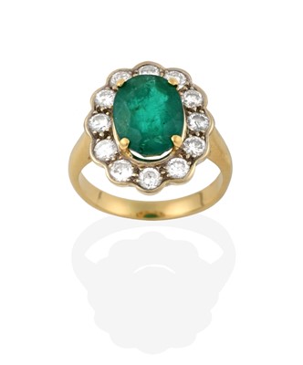 Lot 2302 - An Emerald and Diamond Cluster Ring, the oval...