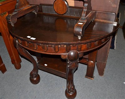 Lot 440 - A carved mahogany demi lune hall table