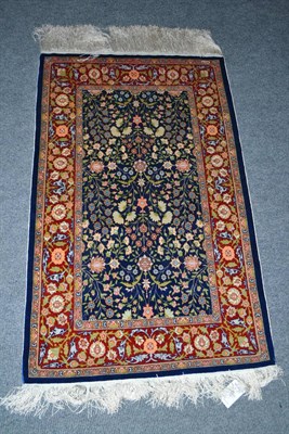 Lot 457 - Hereke silk rug, North West Anatolia, the mid indigo field of scrolling vines enclosed by...