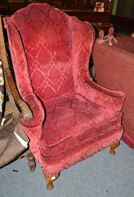 Lot 459 - A 19th century mahogany framed wing armchair upholstered with red cut velvet