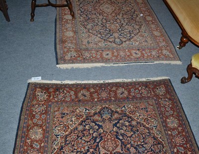 Lot 468 - A pair of Kashan rugs, central Persia, each with an indigo field of scrolling vines centred by...