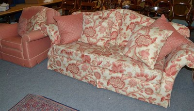 Lot 470 - A large Duresta three piece suite and pouffe with cream and pink floral upholstery and scatter...