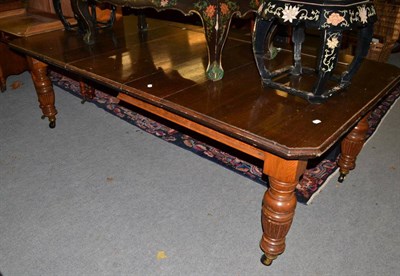 Lot 486 - Late 19th century mahogany dining table on carved oak legs