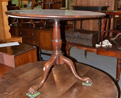 Lot 493 - A 19th century mahogany tip top tripod table on carved feet