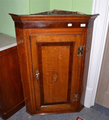 Lot 518 - Georgian light oak and mahogany crossbanded hanging corner cabinet