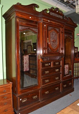 Lot 527 - Victorian carved mahogany triple wardrobe