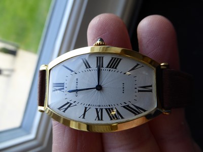 Lot 2102 - Cartier: A Rare Tonneau Shaped 18 Carat Gold Wristwatch