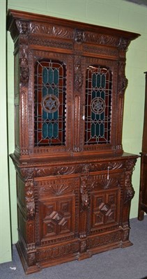 Lot 538 - A Victorian carved oak bookcase, circa 1870, the bold cornice above an acanthus fluted frieze...