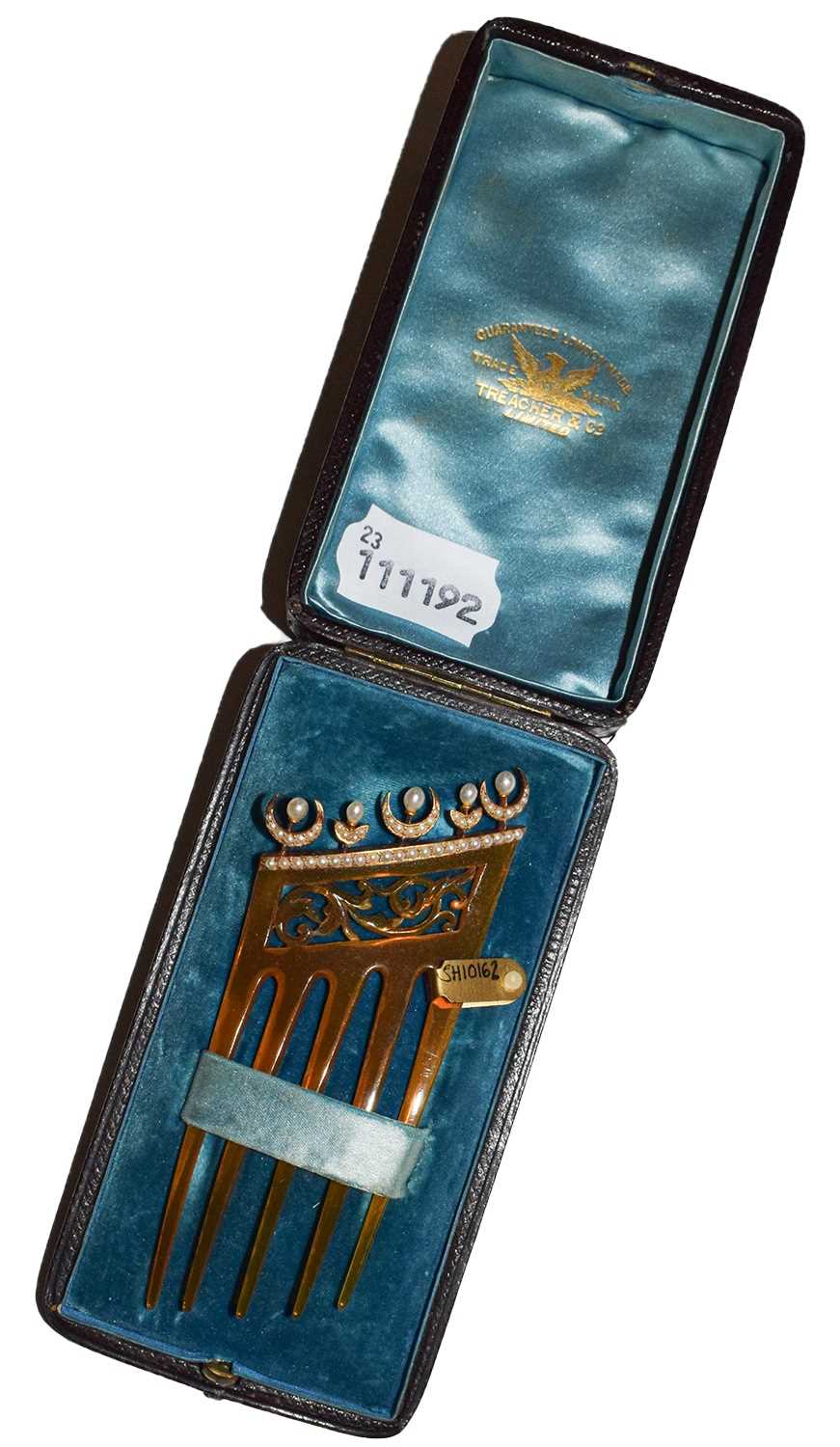 Lot 92 - A composite haircomb decorated with split...