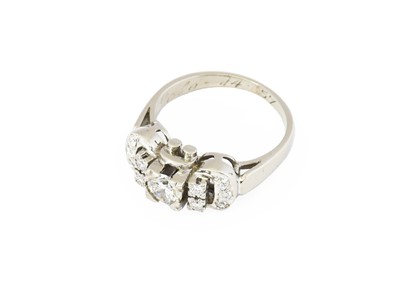 Lot 179 - A diamond cluster ring, the buckle motif set...