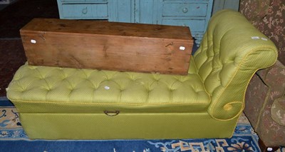 Lot 550 - A green silk upholstered chaise longue with storage