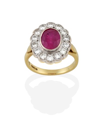 Lot 2333 - A Ruby and Diamond Cluster Ring, the oval cut...