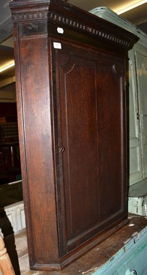 Lot 557 - A Georgian oak hanging corner cabinet