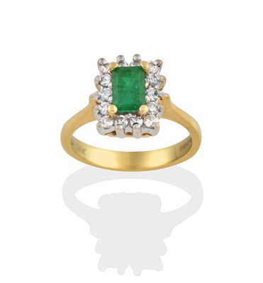 Lot 2323 - An 18 Carat Gold Emerald and Diamond Cluster Ring